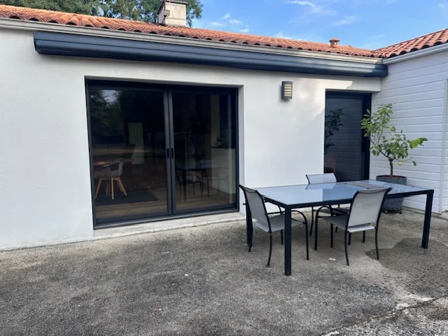 Après remplacement, une baie a galandage moderne et une porte fenêtre. Les deux avec un cadre en aluminium sombre pour un rendu moderne